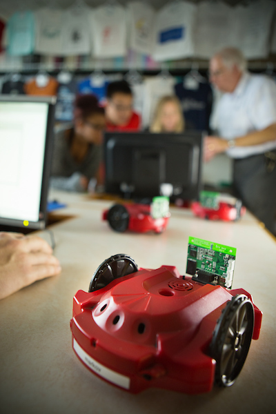 Students working in the lab on Scribbler Robots with faculty'